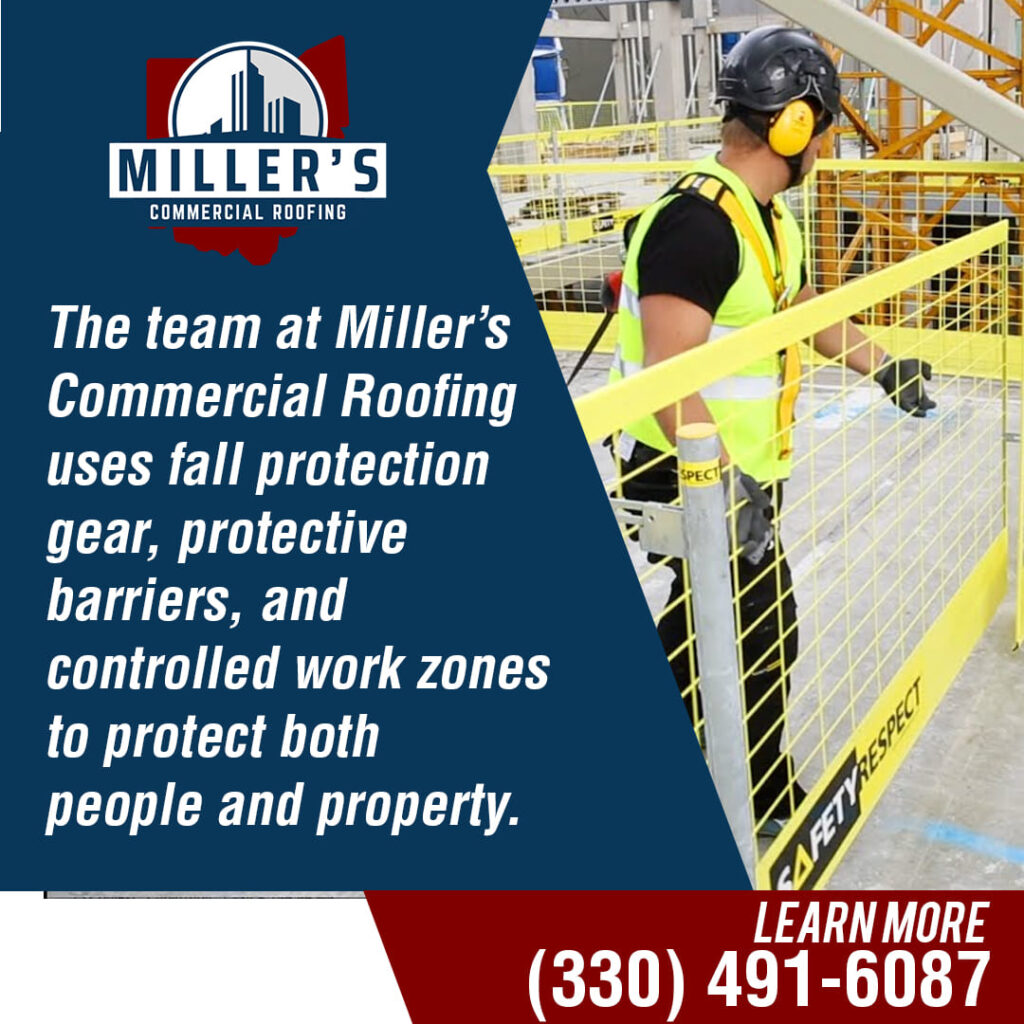 A roofer in bright yellow safety gear, a hard hat, and ear protection works behind a yellow protective barrier on a rooftop, emphasizing safety.